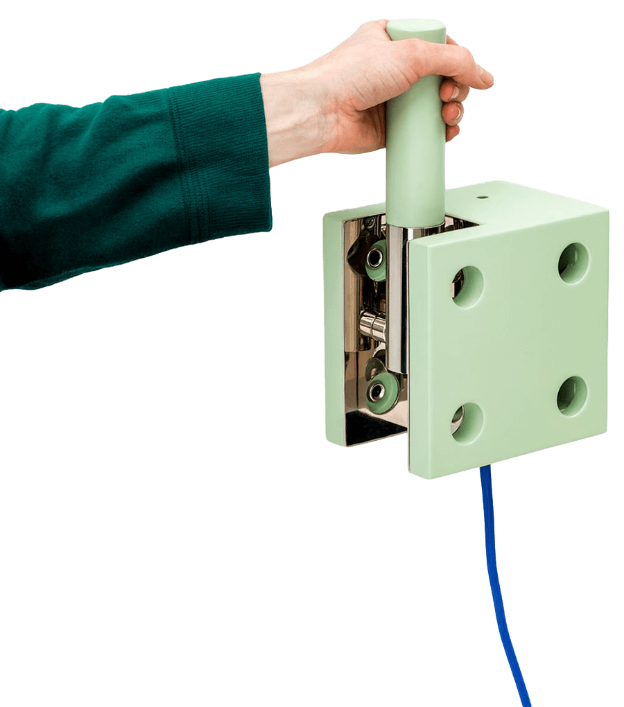 A hand reaching in from the side to grip the top of a core system control device